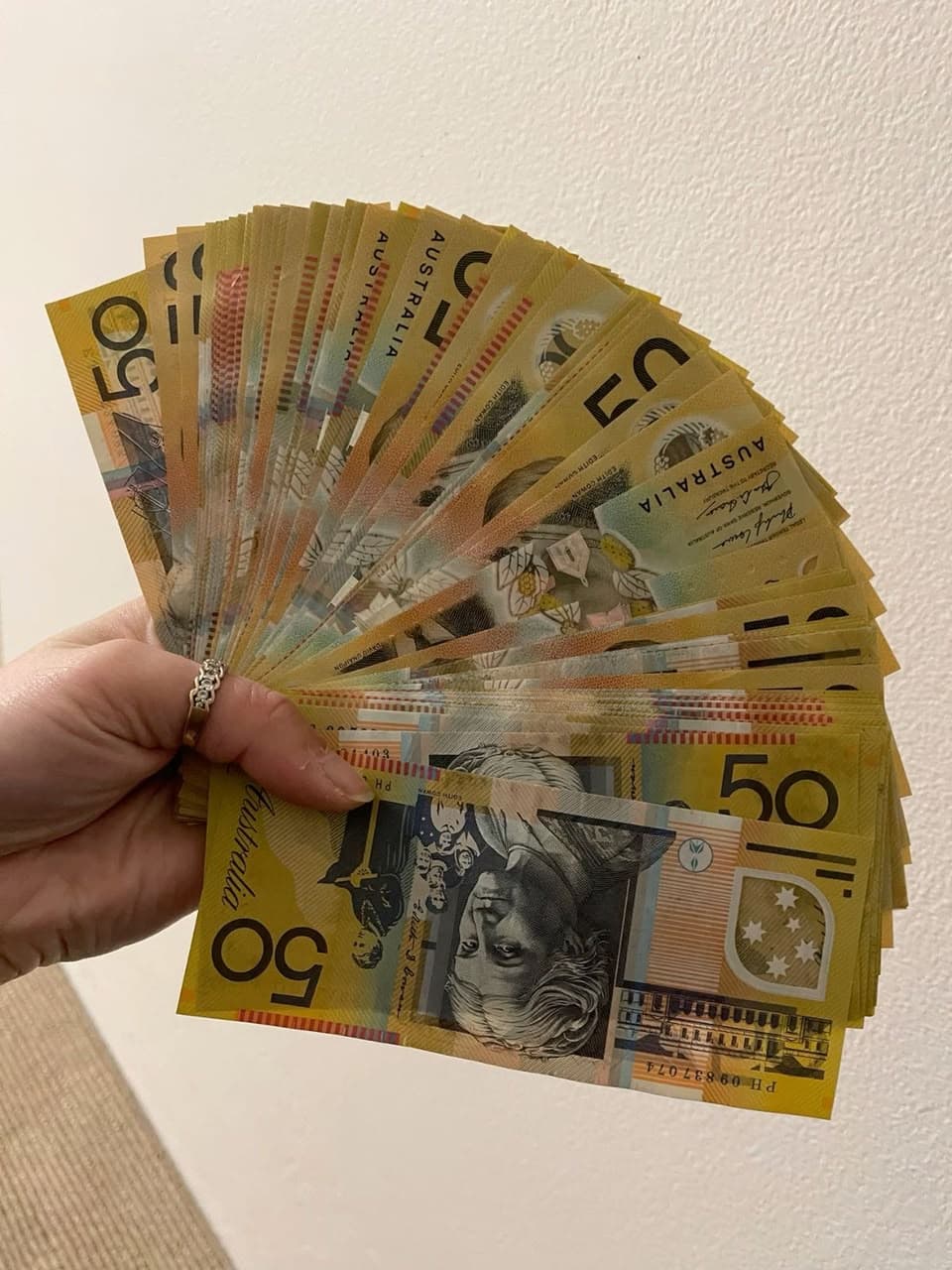 Handheld fan of $50 specimen prop notes shown for print quality